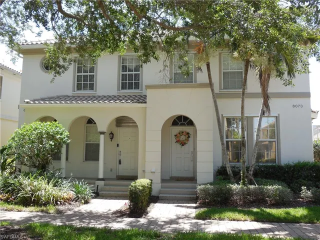 View of front of home featuring stucco siding, entry steps, and a tiled roof