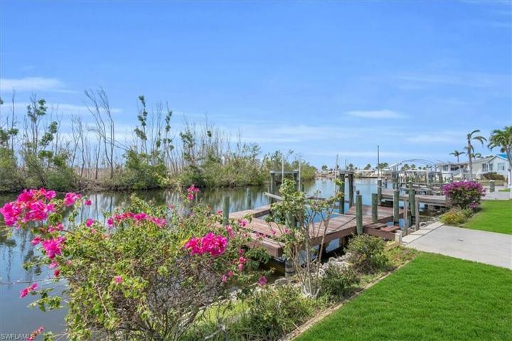 Canal view behind the gardenia in the yard on the seawall