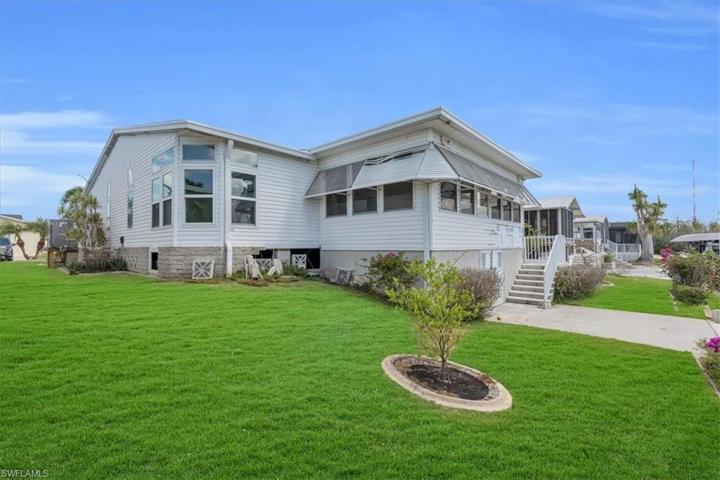 Standing next to the seawall looking at the back of the home