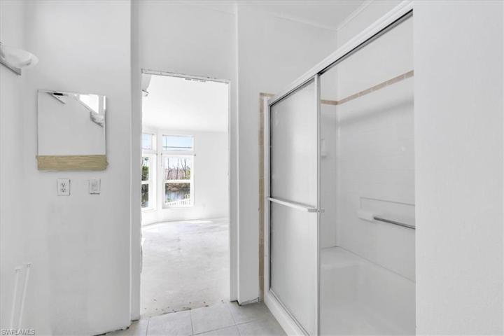 Master bathroom standing next to toilet area