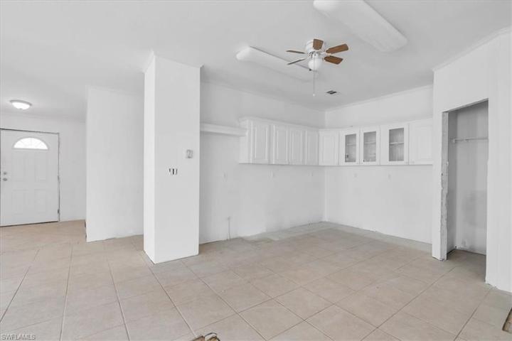 This is standing in the living room at the counter top area looking toward the kitchen and front entry way