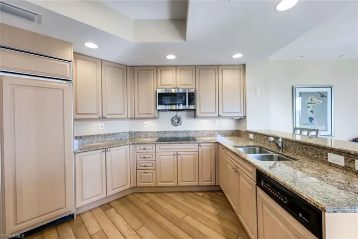 Spacious kitchen with abundant cabinetry and granite counters, offering plenty of room for prep and storage.