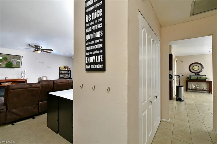 Interior hallway with neutral tone walls and tile flooring