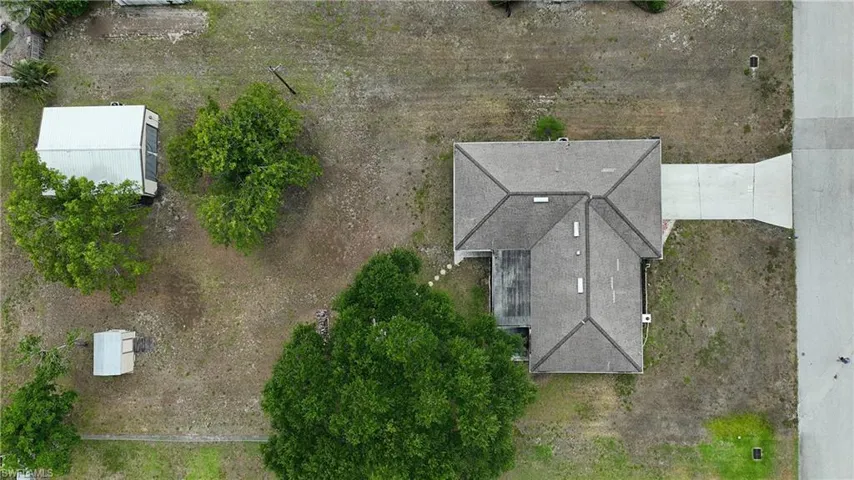 Single-story residence with a gray shingle roof and an attached concrete driveway