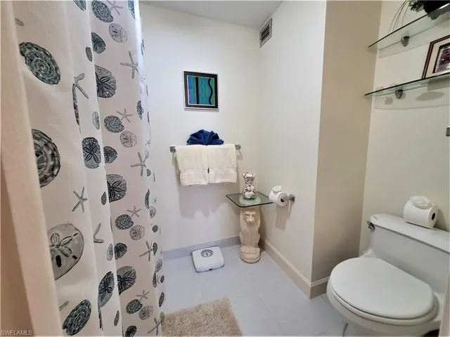 Full bath featuring tile patterned flooring and a stall shower