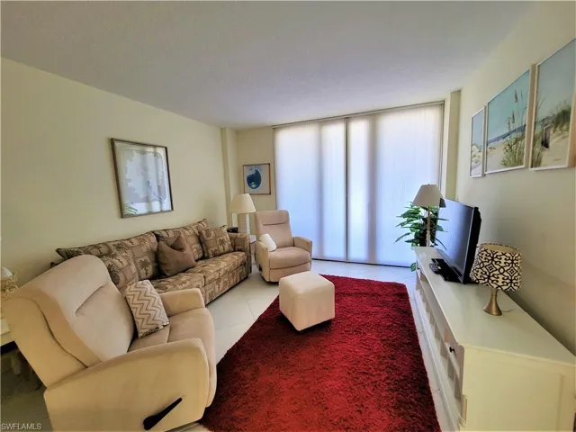 Living room with tile patterned floors and a textured ceiling