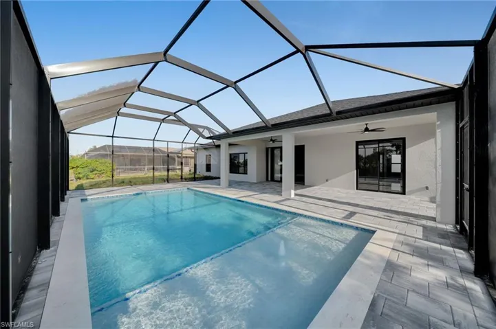Swimming pool featuring a ceiling fan, a patio area, and a lanai