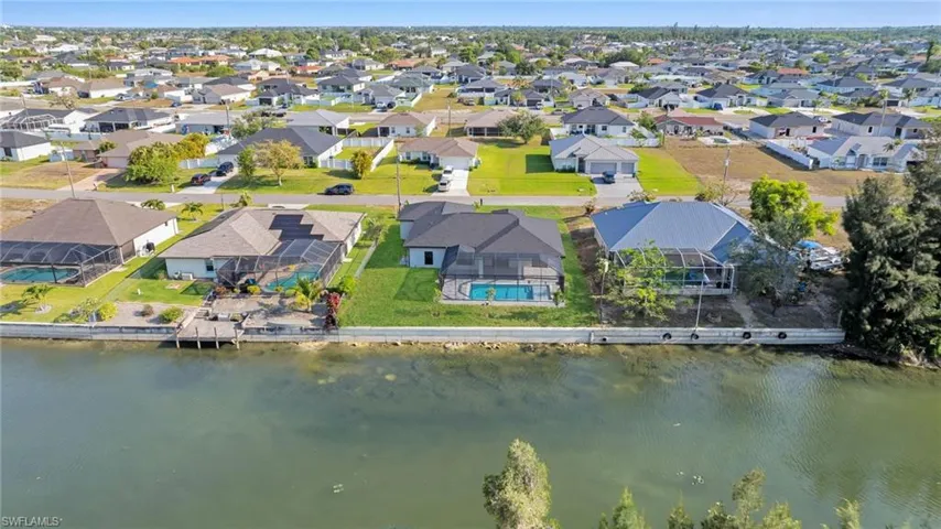 Aerial perspective of suburban area with a nearby body of water