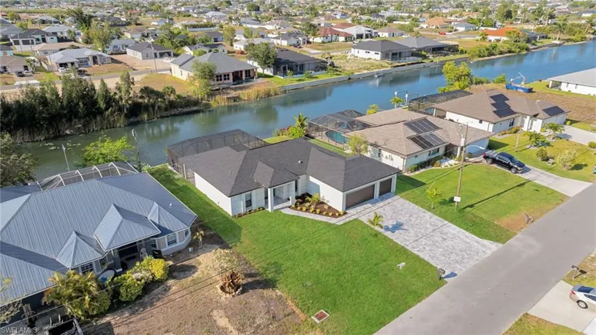 Aerial perspective of suburban area featuring a large body of water