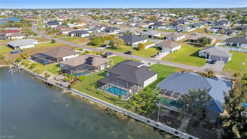 Aerial view of residential area featuring a large body of water