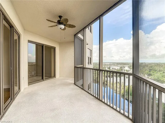 Unfurnished sunroom with a water view and ceiling fan