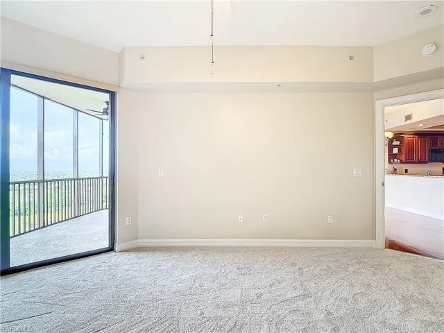 Carpeted empty room featuring ceiling fan