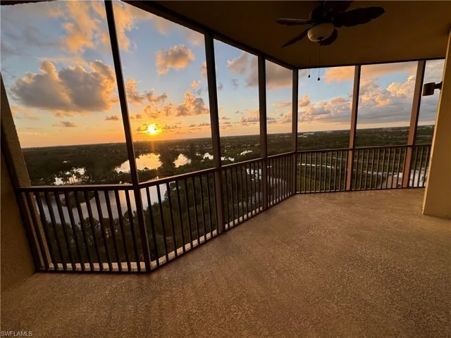 Sunroom / solarium with ceiling fan, a healthy amount of sunlight, and a water view