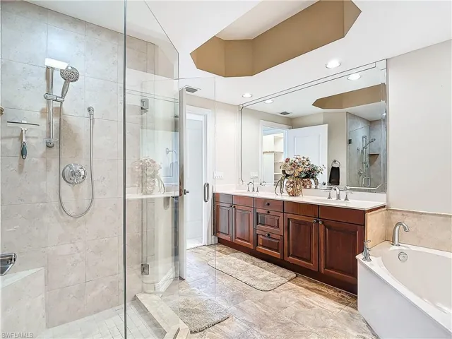 Bathroom featuring vanity and plus walk in shower