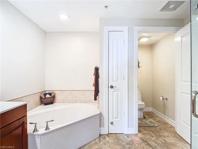 Bathroom with a bathtub, toilet, and vanity