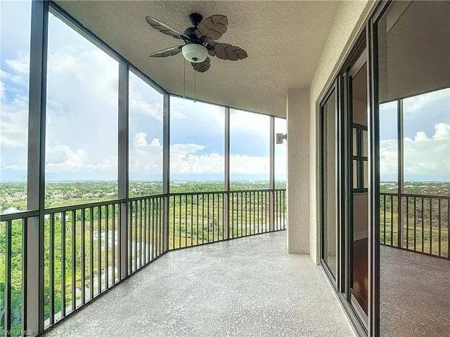 Unfurnished sunroom featuring ceiling fan