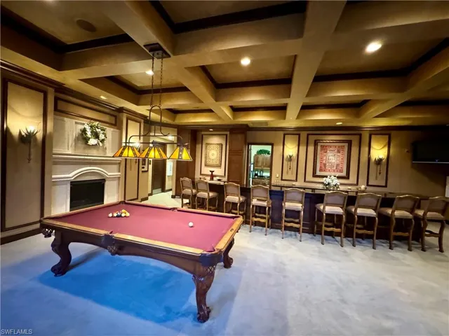 Recreation room with bar, coffered ceiling, pool table, a fireplace, and light colored carpet