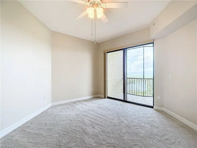 Carpeted spare room with ceiling fan