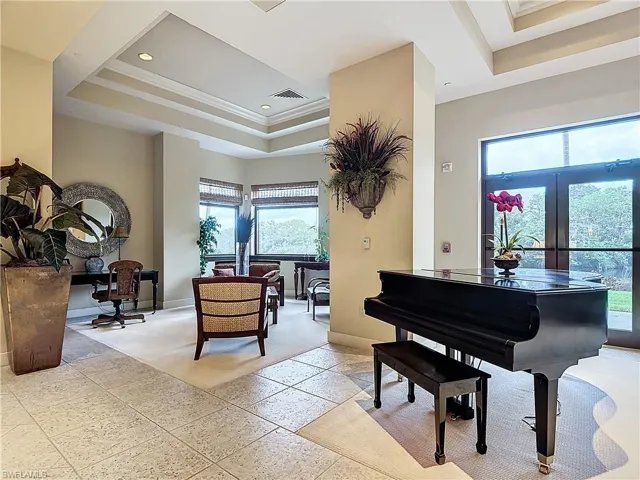Miscellaneous room with a tray ceiling, ornamental molding, and french doors