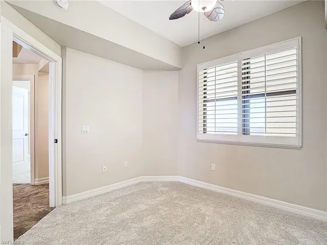 Spare room featuring ceiling fan and carpet flooring