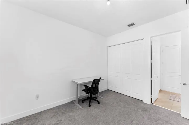 Office featuring light colored carpet
