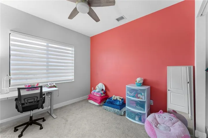 Home office featuring carpet flooring and ceiling fan
