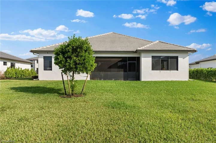 Back of house with a yard