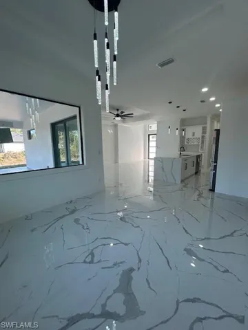 Unfurnished room with light marble finish flooring, recessed lighting, and ceiling fan