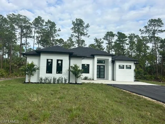 View of front of home featuring a front yard and stucco siding