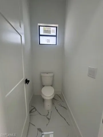 Bathroom with marble finish flooring and baseboards