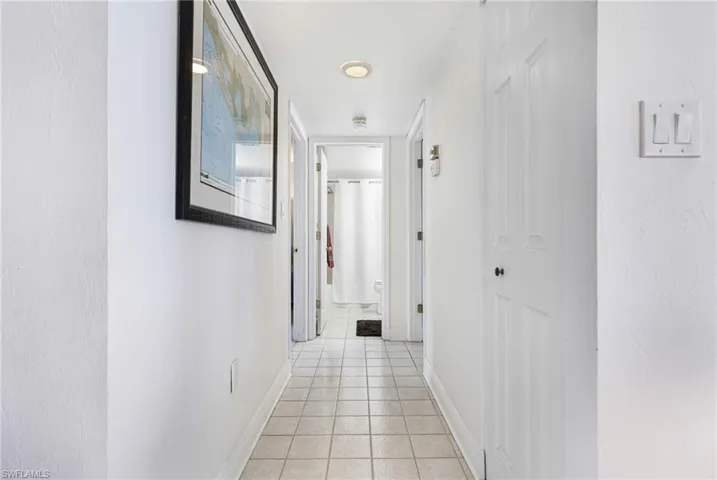 Hallway featuring light tile patterned floors