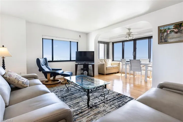 Living room featuring ceiling fan and light wood-type flooring
