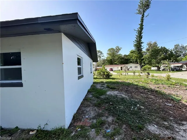 View of side of home with stucco siding