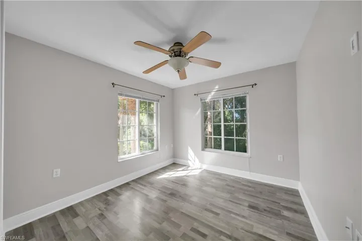 Spare room with light wood finished floors and a ceiling fan