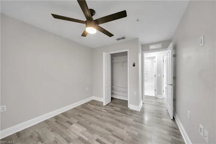 Unfurnished bedroom featuring a closet, light wood finished floors, and a ceiling fan