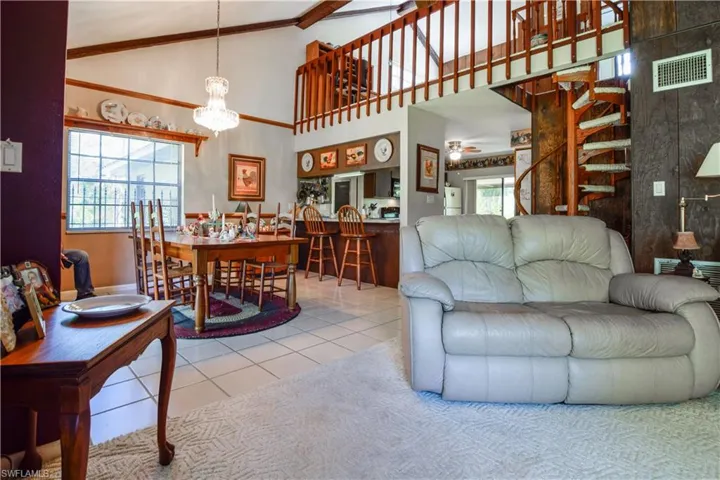 Great Room Area Featuring Soaring Ceilings With A Circular Staircase To The Balcony, Loft, 2nd Bedroom And Bathroom Above.
