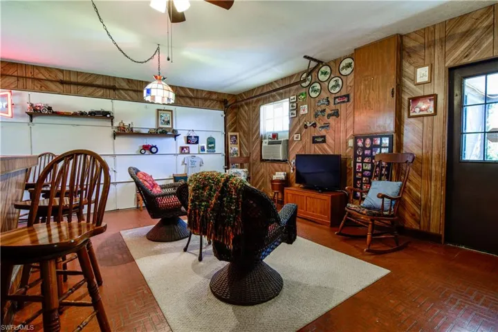 Throw Back Bonus Room With Wood Paneling, Brick Style Floors, Plenty Of Wall Space For Fun Personalized Decor. Tiffany Style Light Fixture And Ceiling Fan Further Adorn This Throw Back Feel.