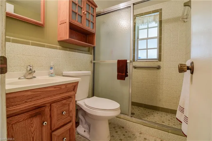 1st Floor Full Bathroom With Beautiful Retro Style Tile Work And Glass Shower Doors.