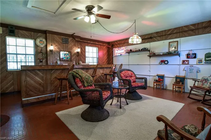 With A 16" Bar As It's Centerpiece, This Throw Back Bonus Room Features: Wood Paneling, Brick Style Floors, Plenty Of Wall Space For Fun Personalized Decor. Tiffany Style Light Fixture And Ceiling Fan Further Adorn This Throw Back Entertaining Space.