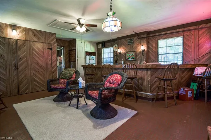 With A 16" Bar As It's Centerpiece, This Throw Back Bonus Room Features: Wood Paneling, Brick Style Floors, Plenty Of Wall Space For Fun Personalized Decor. Tiffany Style Light Fixture And Ceiling Fan Further Adorn This Throw Back Entertaining Space. Additionally, There Is Plenty Of Storage, An Alcove For A Full Sized Refrigerator, And Utility Room With Washer And Dryer Hook Up.