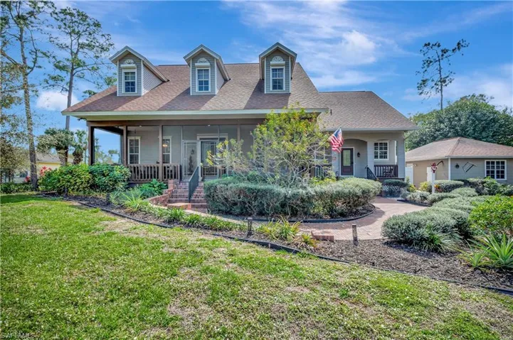 featuring covered porch and a front yard