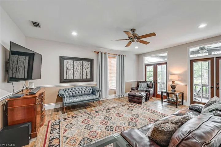Living room featuring ceiling fan, light hardwood / wood-style flooring, and french doors