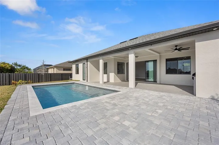 View of pool with ceiling fan and a patio area