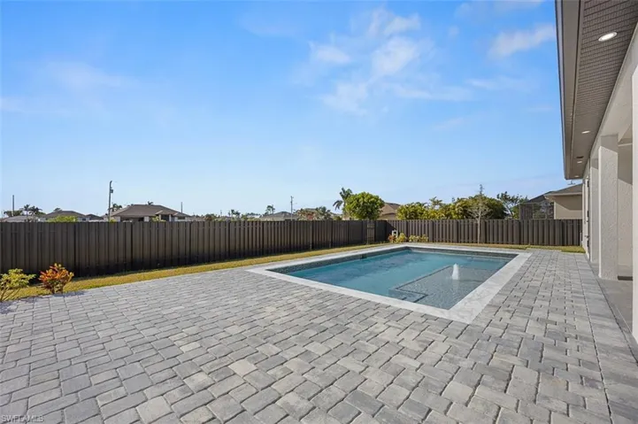 View of pool with a patio and a fenced backyard