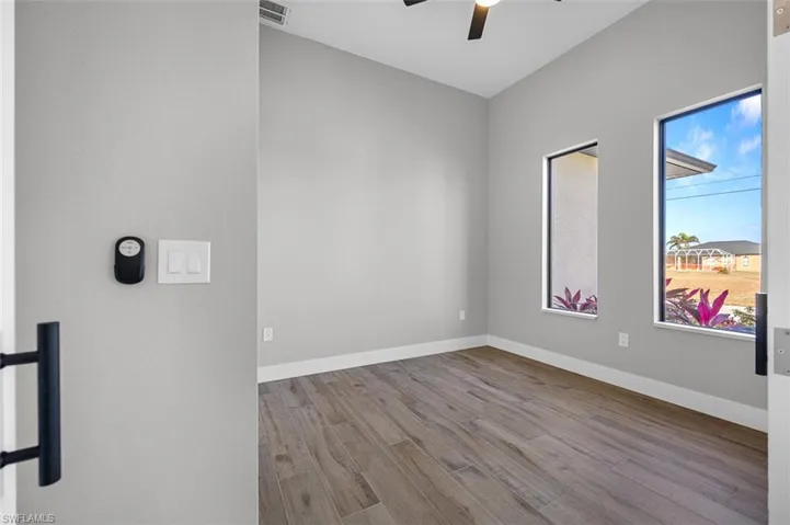 Spare room featuring a ceiling fan and wood finished floors