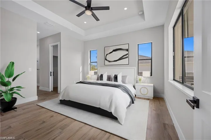 Virtual Staged-Bedroom with wood finished floors, a raised ceiling, ceiling fan, and recessed lighting