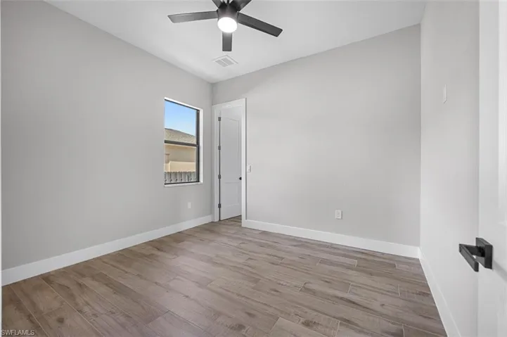 Unfurnished room with ceiling fan and wood finished floors