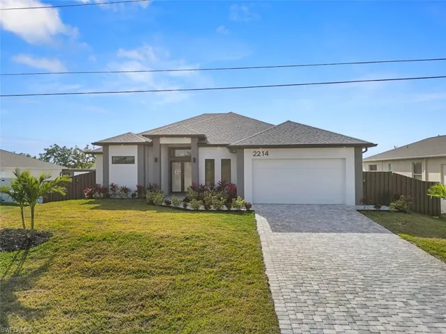 Prairie-style home with stucco siding, an attached garage, decorative driveway, and roof with shingles