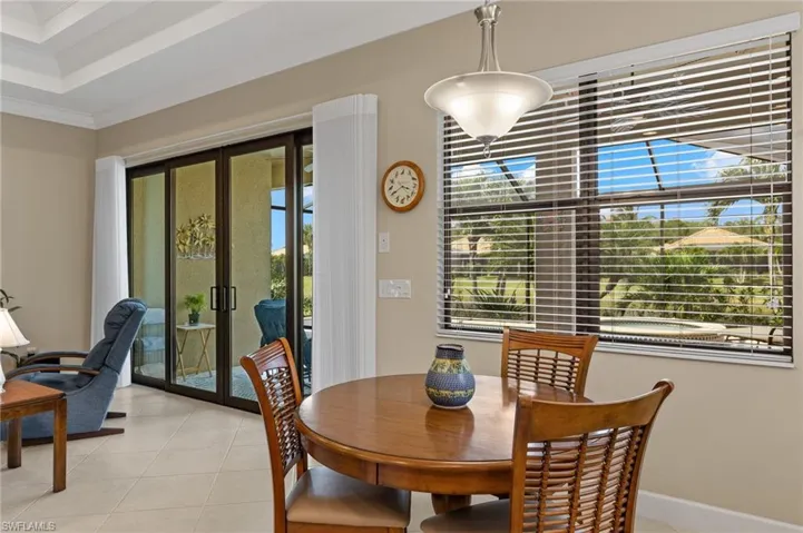 Tiled dining room featuring french doors and crown molding