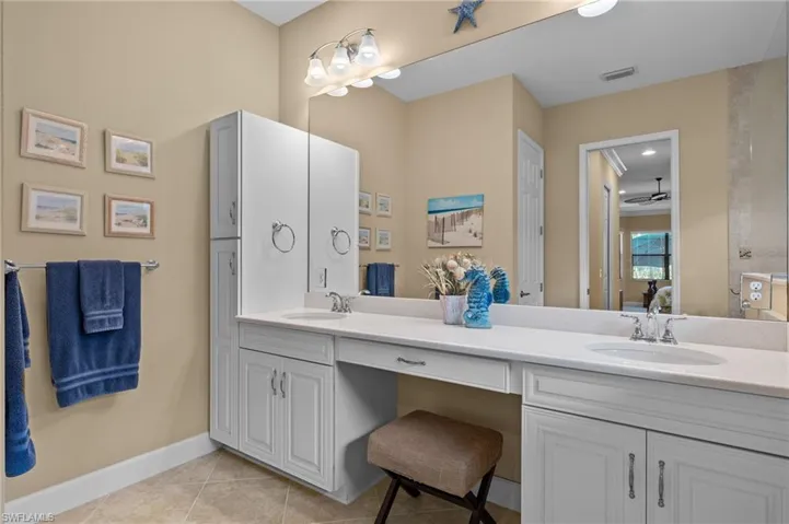 Bathroom featuring tile patterned floors, ceiling fan, and vanity